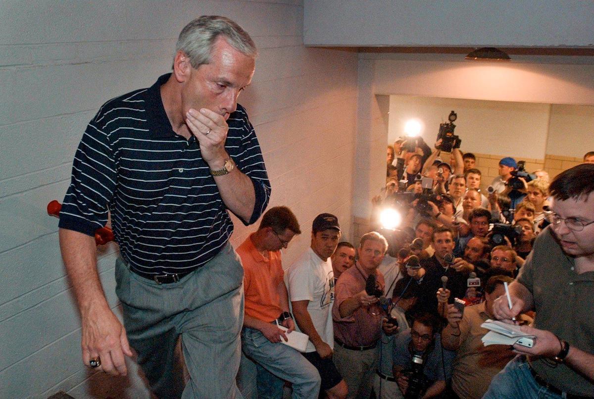 Roy Williams walks away from member of local media at Lawrence after he announced in 2003 that he would be leaving Kansas to coach at UNC.