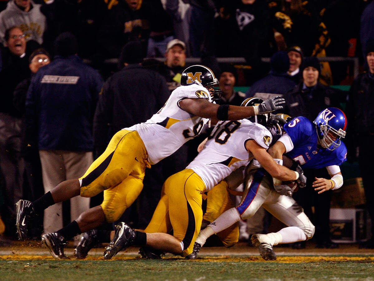 Stryker Sulak #38 of the Missouri Tigers sacks quarterback Todd Reesing #5 of the Kansas Jayhawks in the end zone for a safety during the final minute of the game at Arrowhead Stadium November 24, 2007 in Kansas City, Missouri.
