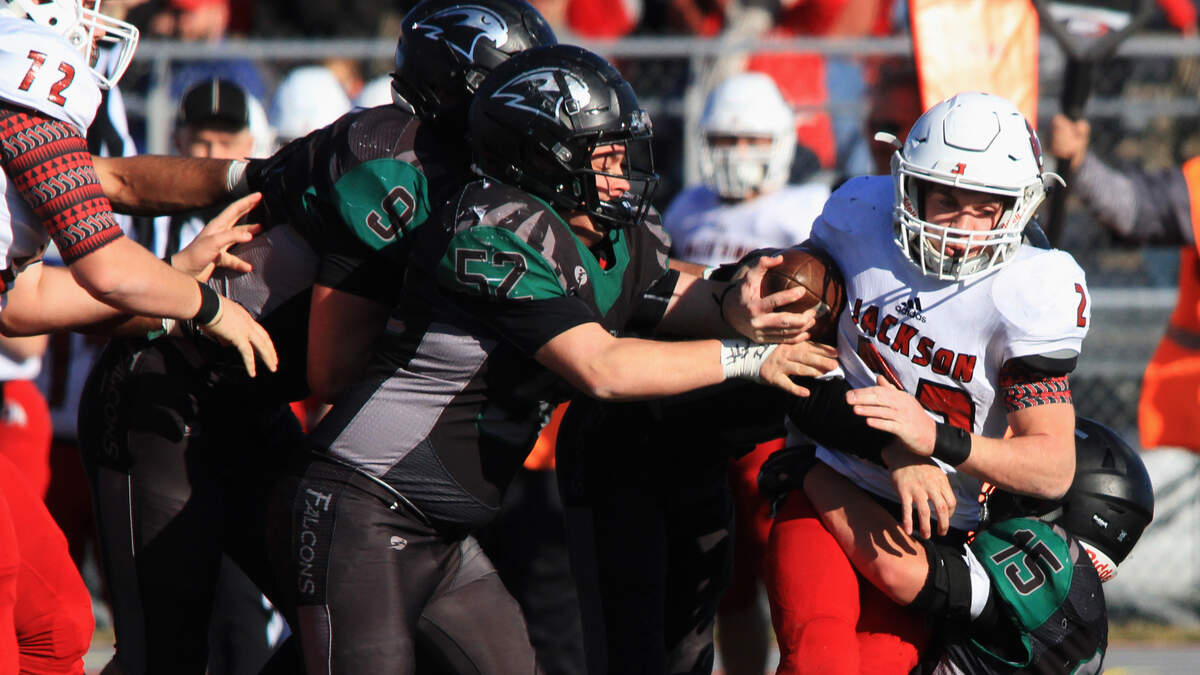 Three Staley defenders, Nick Wright, left, Mason Kever and Braden Robertson, team up to take down Jackson wide receiver Seth Waters during Saturday’s Missouri Class 5 semifinal at North Kansas City’s District Activities Complex. The Falcons fell 20-7 and Jackson advanced to the Show Me Bowl.