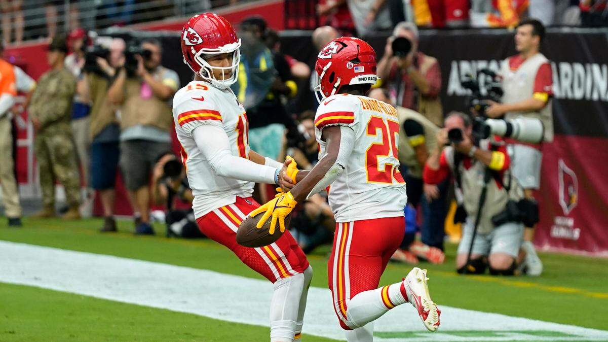 Kansas City Chiefs quarterback Patrick Mahomes, left, celebrates after running back Clyde Edwards-Helaire (25) scored a touchdown against the Arizona Cardinals during the first half of an NFL football game, Sunday, Sept. 11, 2022, in Glendale, Ariz.