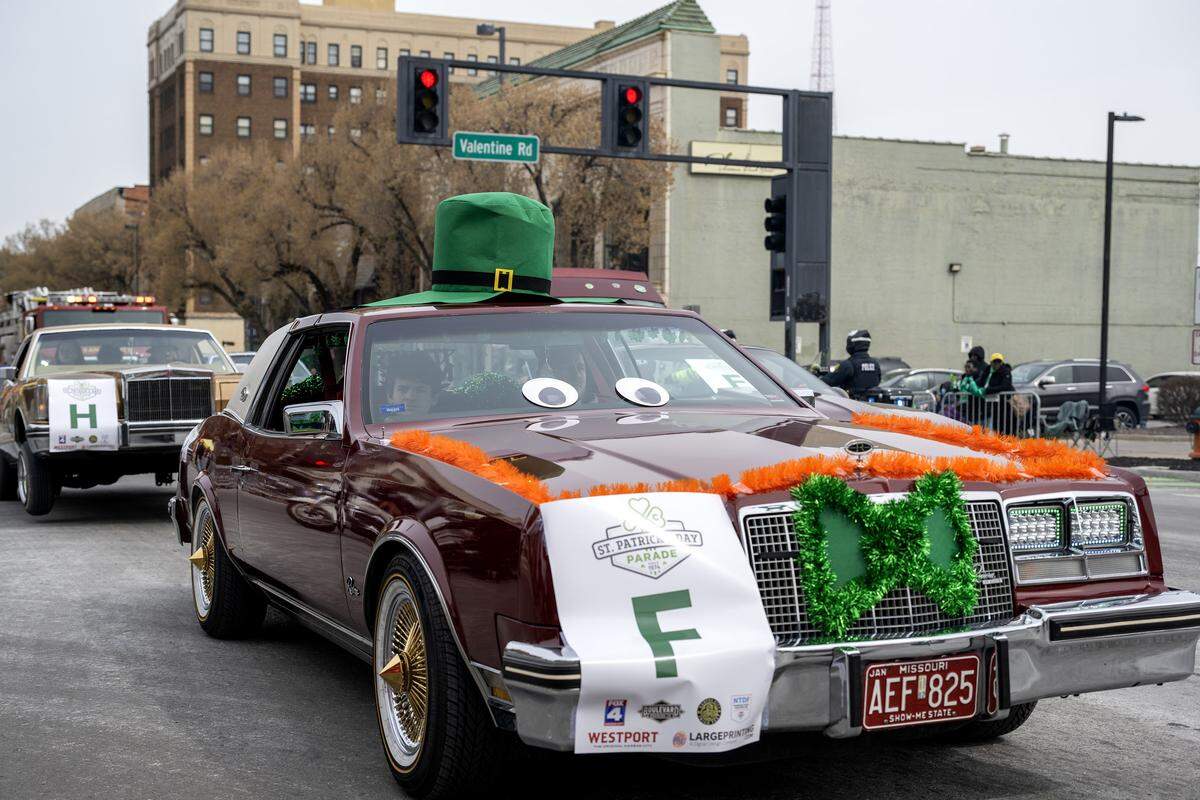 Lowrider cars use hydraulic suspension to hop during the St. Patrick's Day parade along Broadway Boulevard on Tuesday, March 17, 2026, in Kansas City.