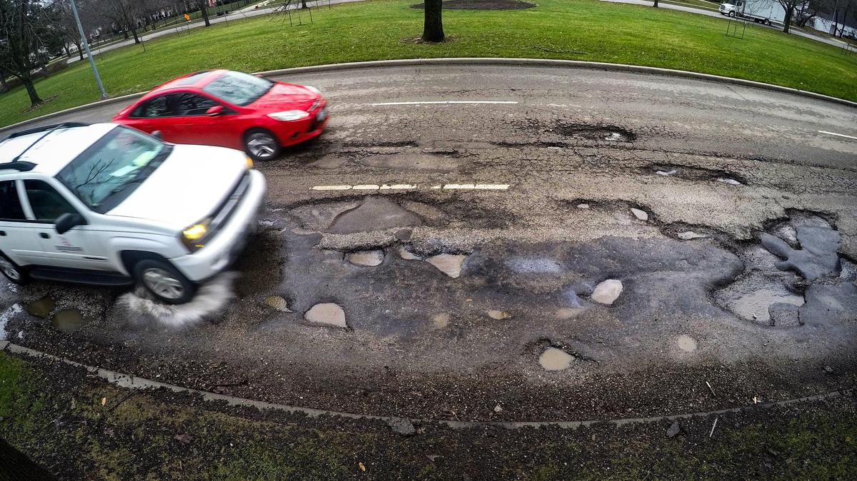 These potholes located along Ward Parkway were filled with asphalt as a temporary fix shortly after they were photographed on Friday, March 29, 2019.
