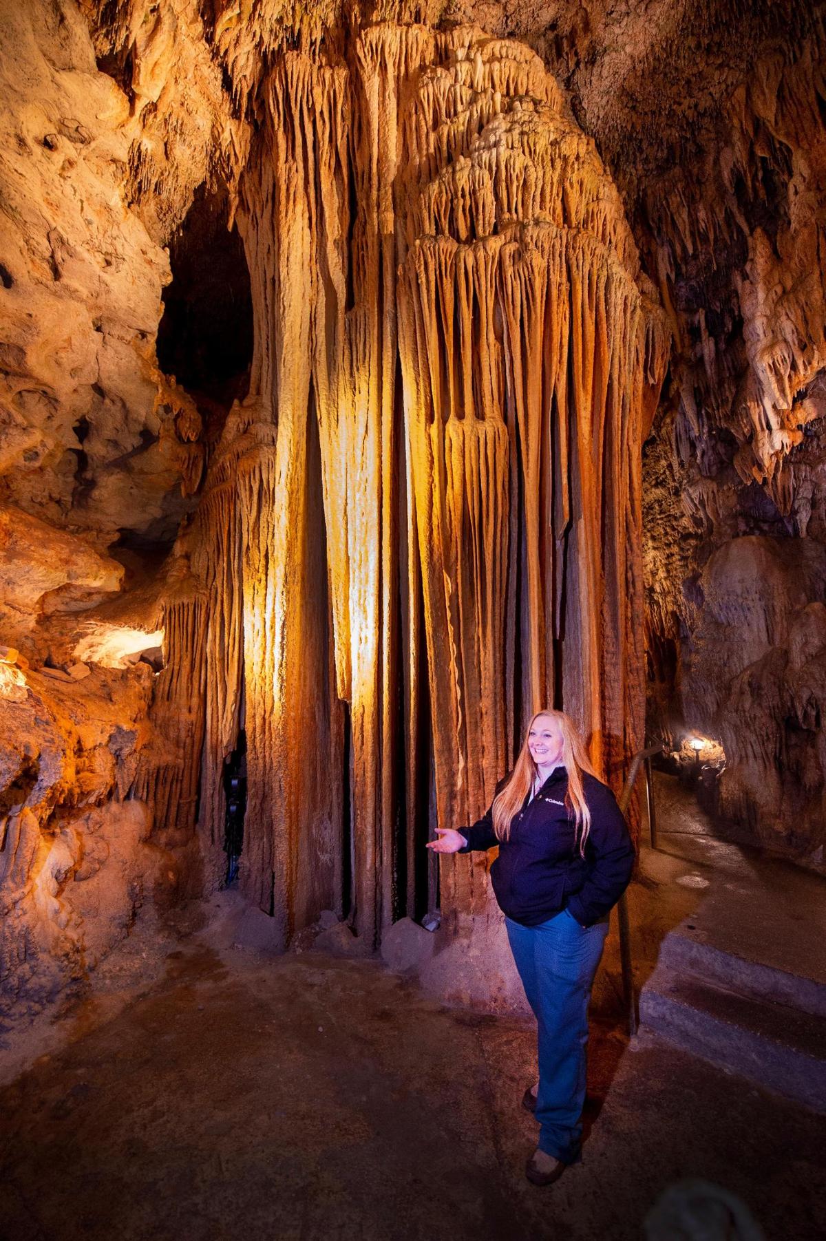 In Bridal Cave, Lindsey Webster-Dillon shows a formation called The Pipe Organ in the Bridal Room, where over 4,000 couples have held weddings.