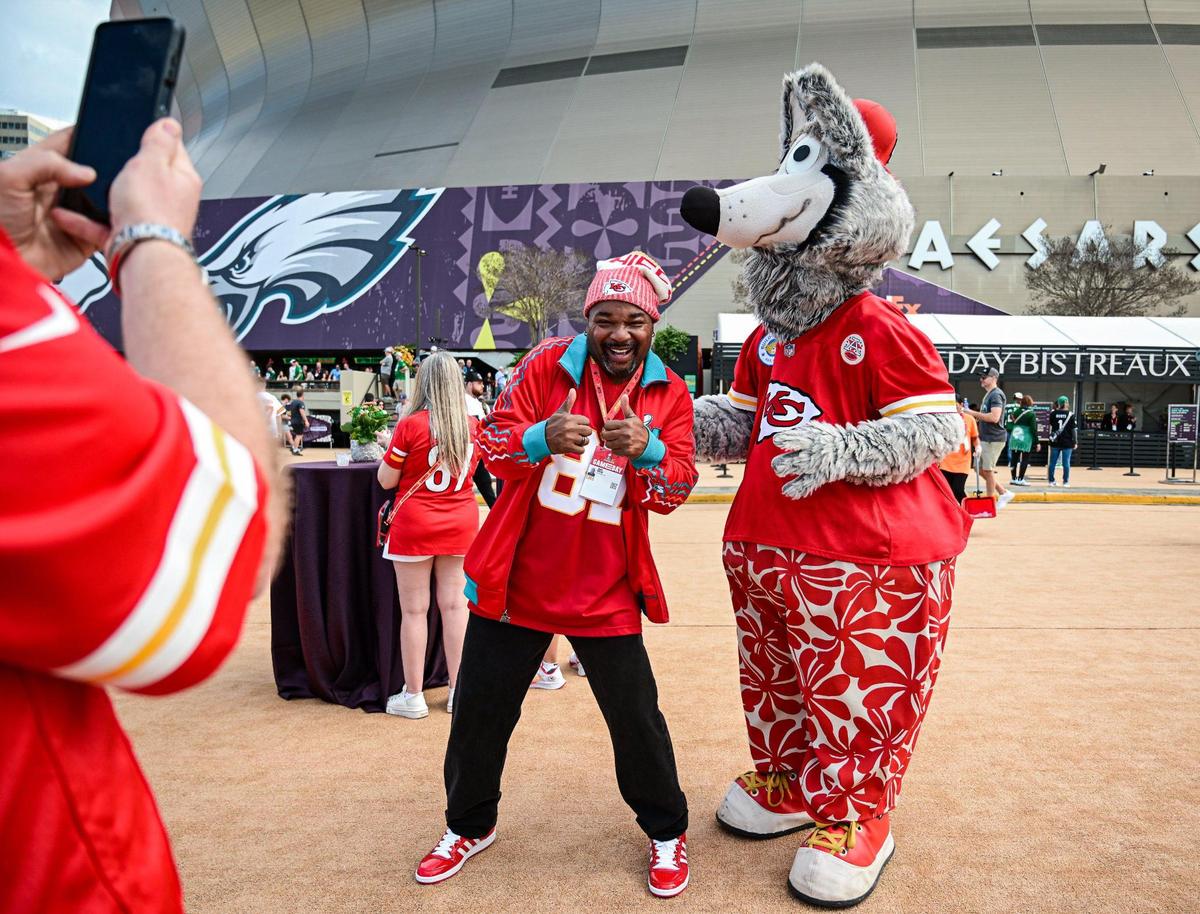 Kansas City Chiefs fan Juan Welch of Phoenix, Arizona, poses for a photo with Chiefs mascot KC Wolf outside of Caesars Superdome before the start of Super Bowl LIX on Feb. 9, 2025, in New Orleans.