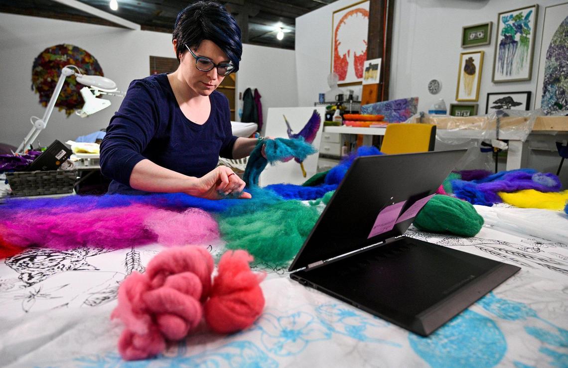 In her West Bottoms studio, Rachelle Gardner-Roe works on her “Flyover Country: The Wild Side” artwork, which is a tongue-in-cheek piece on the view both coasts have of the Midwest. She said images in the panels show things in nature that can be found in Kansas or Missouri that an air traveler might fly over.
