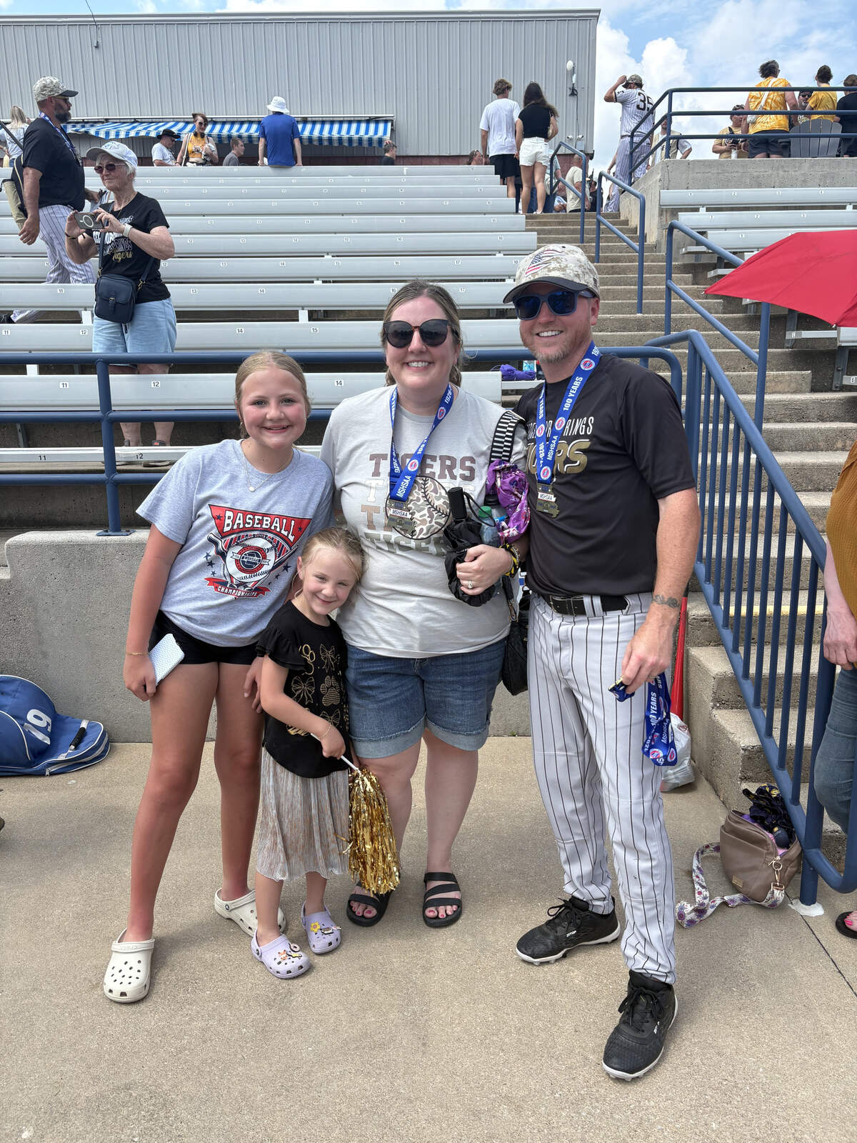 Head coach Cody Vaughn (far right) pictured with Cale Lyons’ wife, Regan (middle), and her two daughters after winning the 2026 4A State title.