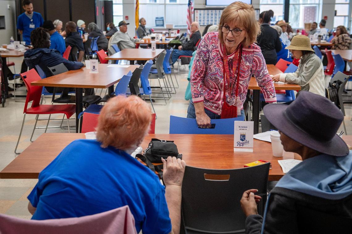 Don Bosco Senior Center director Anne Miller talks to center patrons during lunch on Thursday, March 27, 2025. Miller says she stays on top of developments with Social Security Administration policies to be able to pass along policy changes to Don Bosco clients.