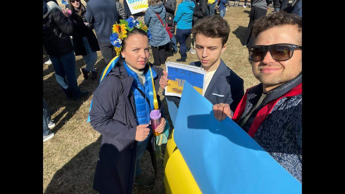 Iryna Yeromenko, 41, her 18-year-old son and husband at the rally to support Ukraine at the Country Club Plaza on Feb. 26, 2022.