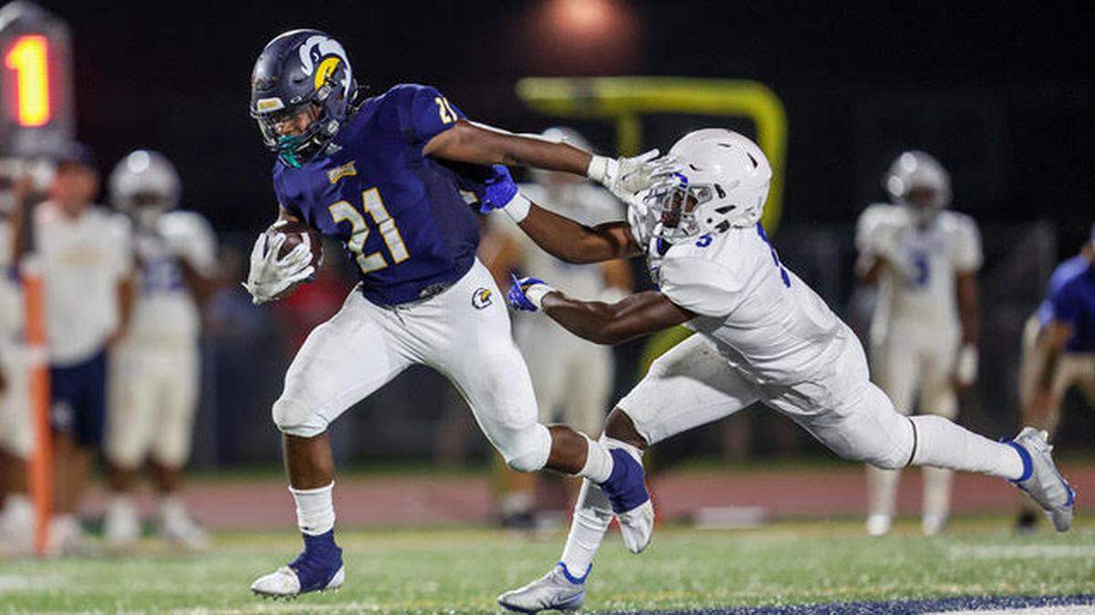 Liberty North’s MicahJo Barnett shakes off a tackler during the Eagles’ early-season win against Rockhurst.