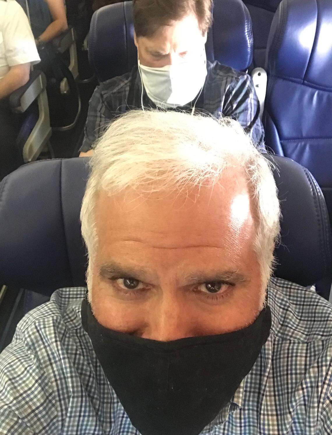 Vahe Gregorian, foreground, and Blair Kerkhoff, at rear, were properly socially distanced and masked up for the flights to and from L.A.