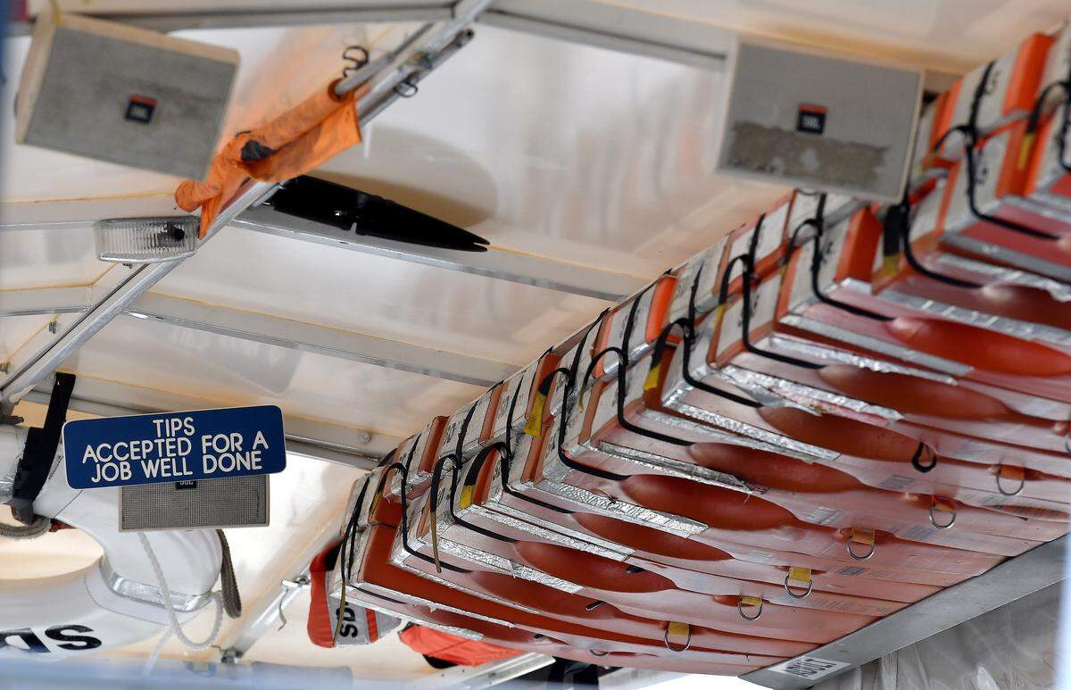 Life jackets sit above seats in a duck boat parked at the Ride the Ducks offices on Saturday, July 21, 2018, in Branson, Mo.