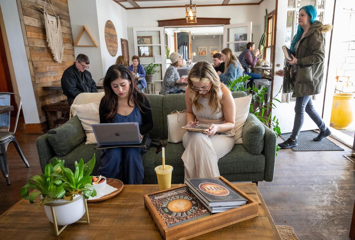 Jacqueline Minjares, left, of De Soto and Allison Emry of Olathe meet to talk business at Cause Coffee.