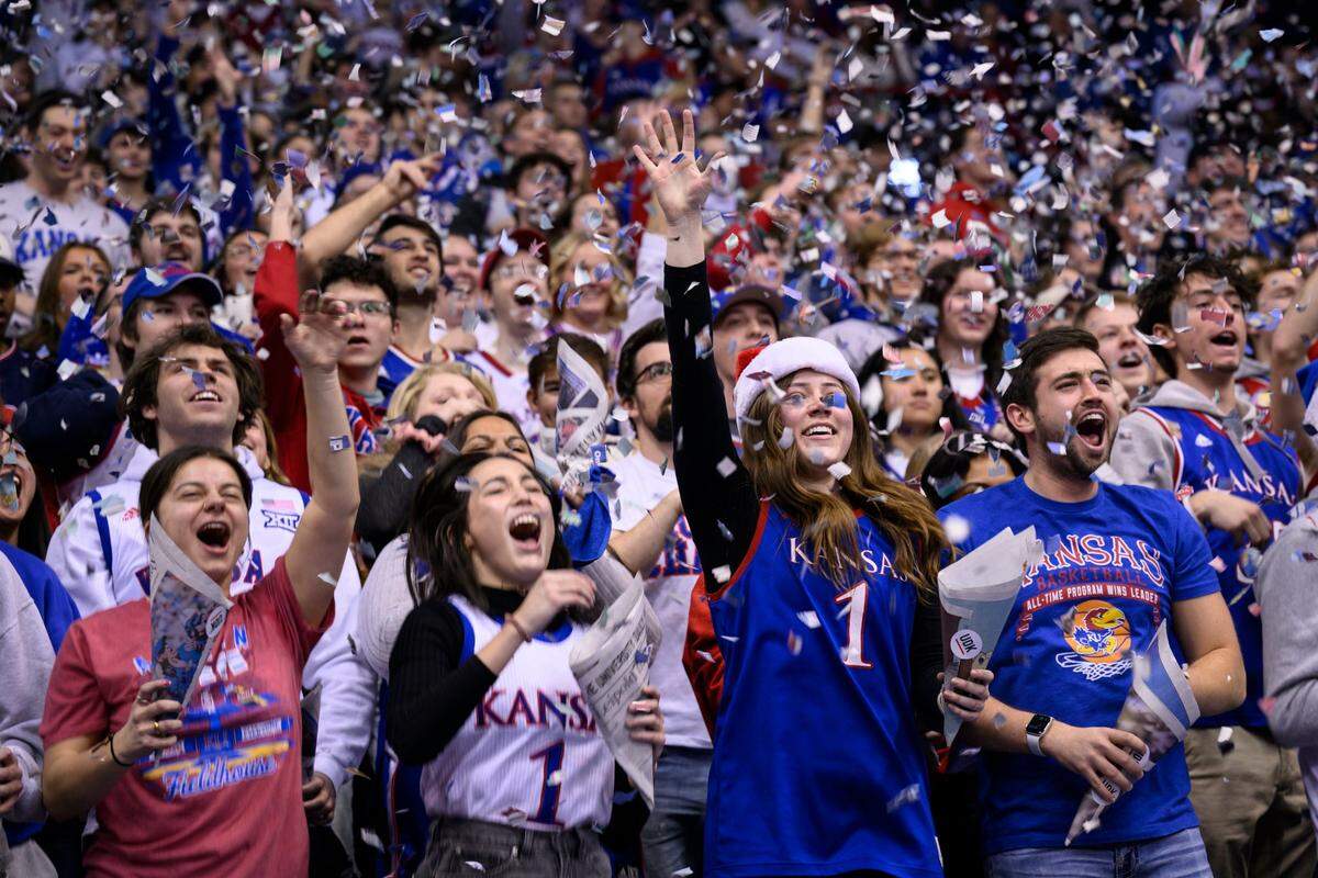 Kansas fans cheer and throw confetti before the start of the game against Indiana in Lawrence, Kan., Saturday, Dec. 17, 2022.