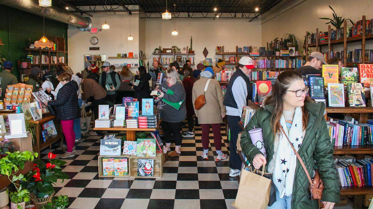 Several customers are seen at Monstera’s Books for the store’s reopening on Dec. 6, 2025. The store closed for a little over three months while renovations took place after a fire in a restaurant next door.