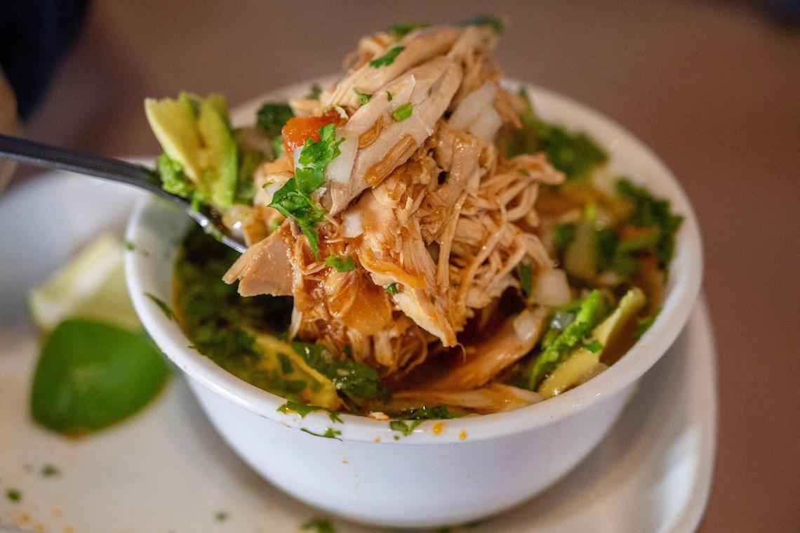 A bowl of chicken soup with avocado, cilantro and lime is served at La Fonda El Taquito.