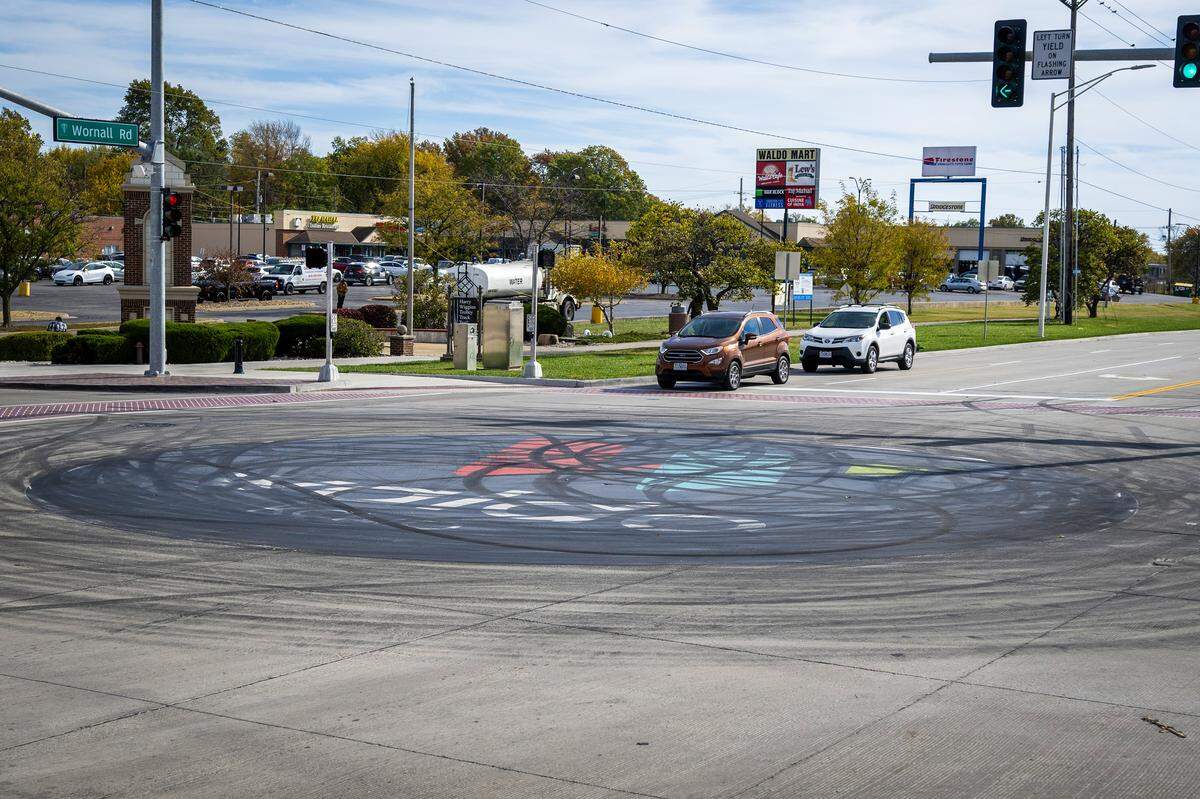 The street art logo in the middle of the intersection of 75th Street and Wornall Road is seen on Tuesday, Nov. 4, 2025, in Kansas City. The recently placed logo which celebrates the Waldo neighborhood was damaged by tire skid marks from an illegal sideshow over the weekend.