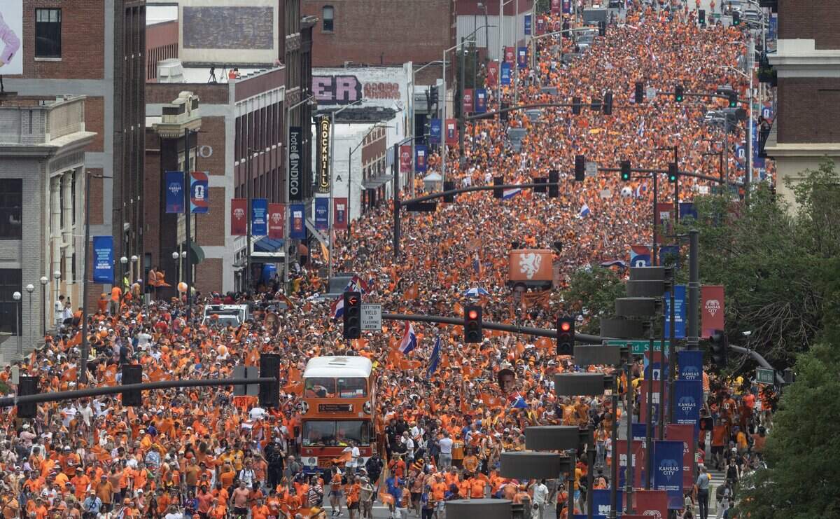 Thousands of Netherlands soccer fans, joined by thousands of Kansas Citians, parade through downtown Kansas City on Thursday, June 25, 2026.