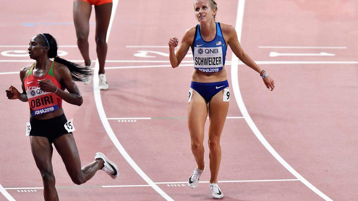 Hellen Obiri, of Kenya, left, and Karissa Schweizer, of the United States, cross the finish line of the women’s 5000 meter heats at the World Athletics Championships in Doha, Qatar, Wednesday, Oct. 2, 2019. (AP Photo/Martin Meissner)