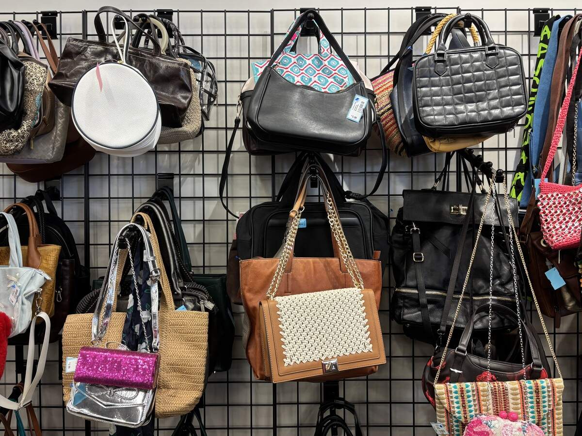 Bags hang on hooks against a wall.