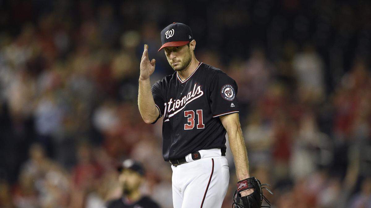 Washington Nationals starting pitcher Max Scherzer gestures form the mound after he recorded his 300th strikeout of the season during the seventh inning of a baseball game against the Miami Marlins, Tuesday, Sept. 25, 2018, in Washington. (AP Photo/Nick Wass)