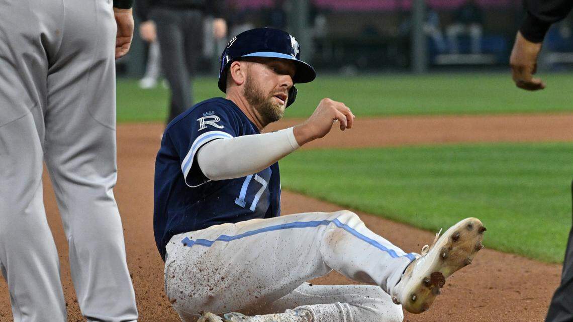 Kansas City Royals third baseman Hunter Dozier (17) slides into third base after hitting a two-RBI triple during the seventh inning against the Oakland Athletics at Kauffman Stadium on May 5, 2023.
