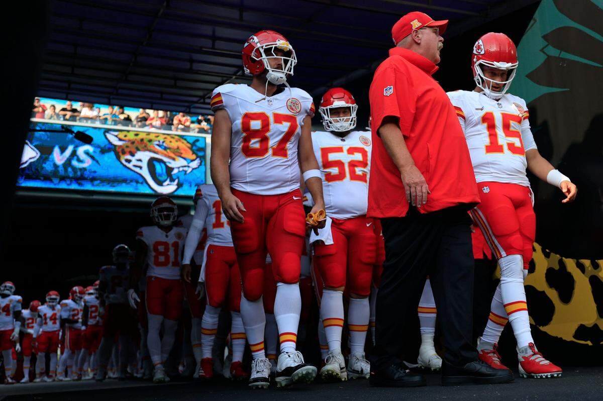 Kansas City Chiefs head coach Andy Reid, center, talks to quarterback Patrick Mahomes (15) next to tight end Travis Kelce (87) before a preseason NFL football game on Aug. 10, 2024 at EverBank Stadium in Jacksonville, Florida.