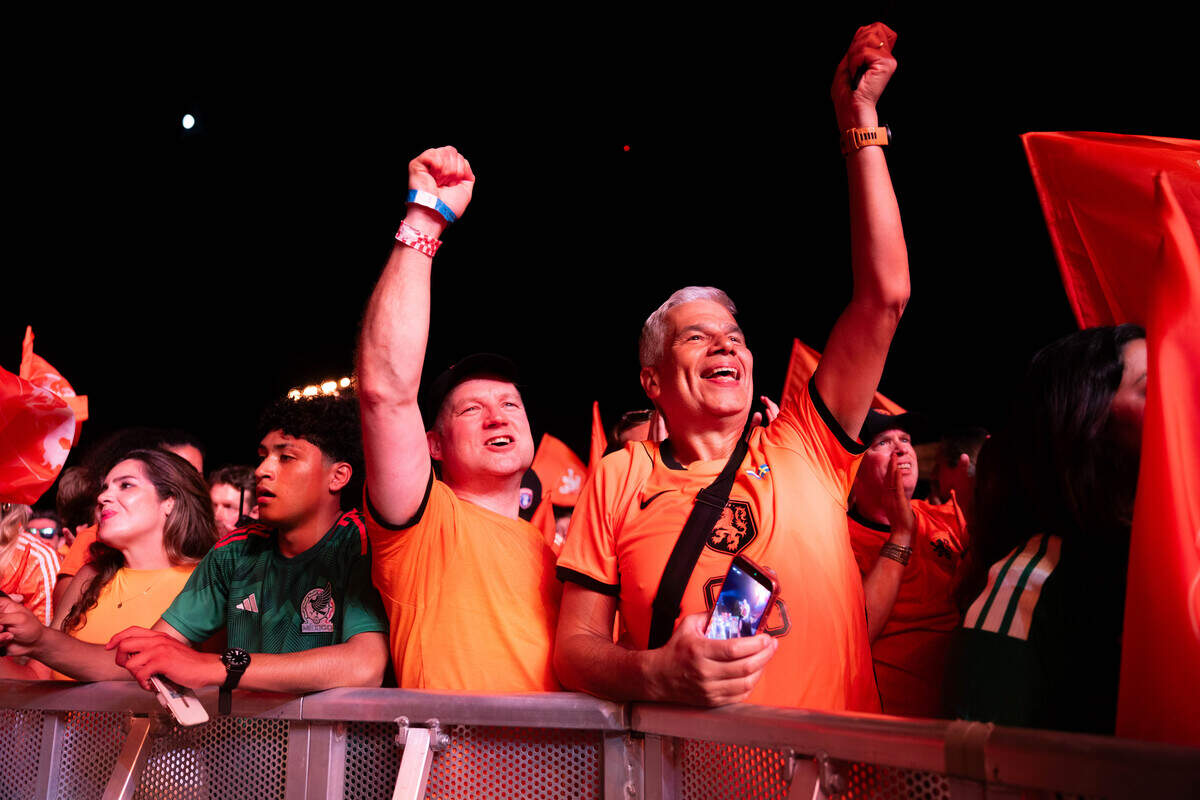 Dutch supporters throw their arms in the air as they celebrate their team during the Bij Oranje Party at Fan Fest on Wednesday, June 24, 2026.