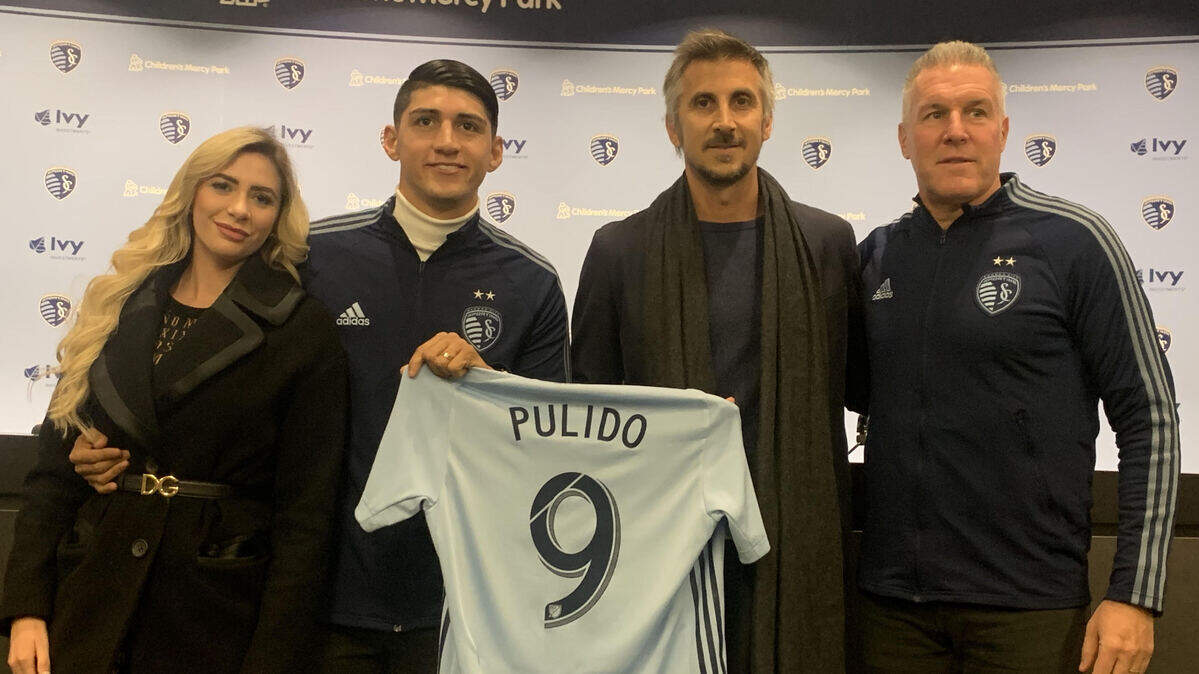 Mexican soccer player and new Sporting KC signee Alan Pulido, second from left with his wife, joined Sporting KC scout and former player Santiago Hirsig, second from right, and Sporting manager and director Peter Vermes in an introductory session with media Tuesday at Children’s Mercy Park.