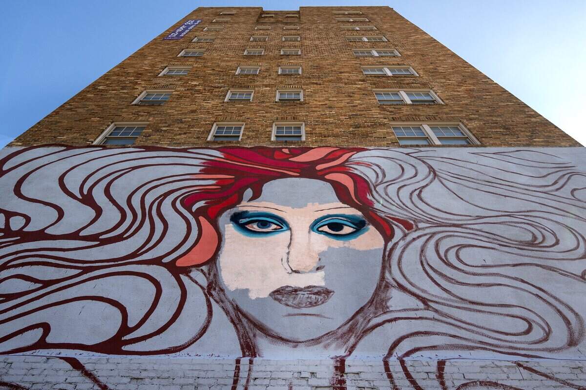 A mural of pop singer Chappell Roan takes shape along Broadway Boulevard on Wednesday, Sept. 24, 2025, in Kansas City. Artists Christine Riuzel and Jared Horman are collaborating on the project.