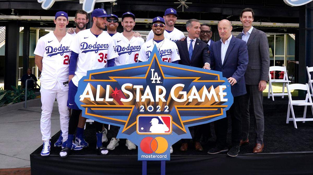 Members of the Los Angeles Dodgers, left, Los Angele mayor Eric Garcetti, fourth from right, and Dodgers’ president and CEO Stan Kasten, second from right, pose during an event to officially launch the countdown to MLB All-Star Week Tuesday, May 3, 2022, at Dodger Stadium in Los Angeles. The All-Star Game is scheduled to be played on July 19. (AP Photo/Mark J. Terrill)