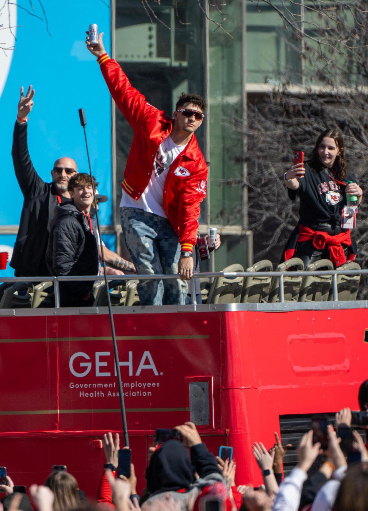 Kansas City Chiefs quarterback Patrick Mahomes holds a beer as he rides a bus during the Kansas City Chiefs Super Bowl LVIII championship parade on Wednesday, Feb. 14, 2024, at Union Station in Kansas City.