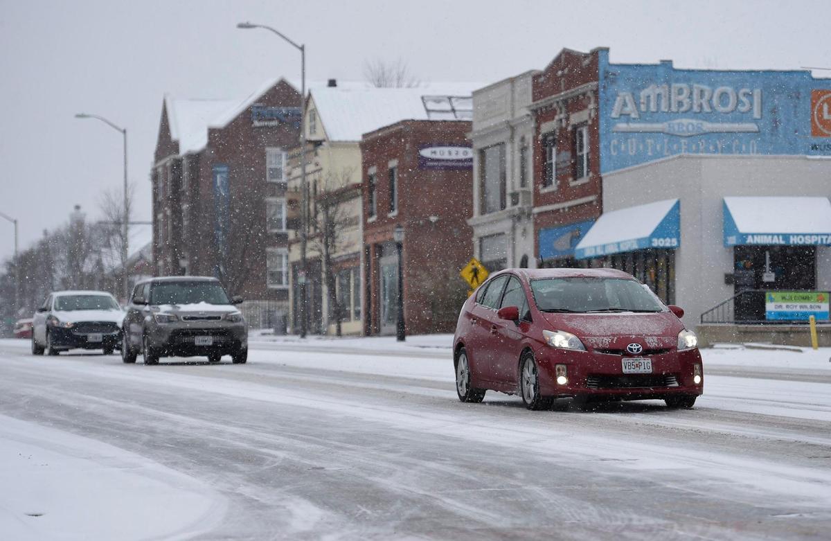 Cars drove slowly down Main Street in Midtown Kansas City as a winter snow storm was moving through the metro area and leaving snow and frigid temperatures in its wake on Saturday, Feb. 6, 2012.