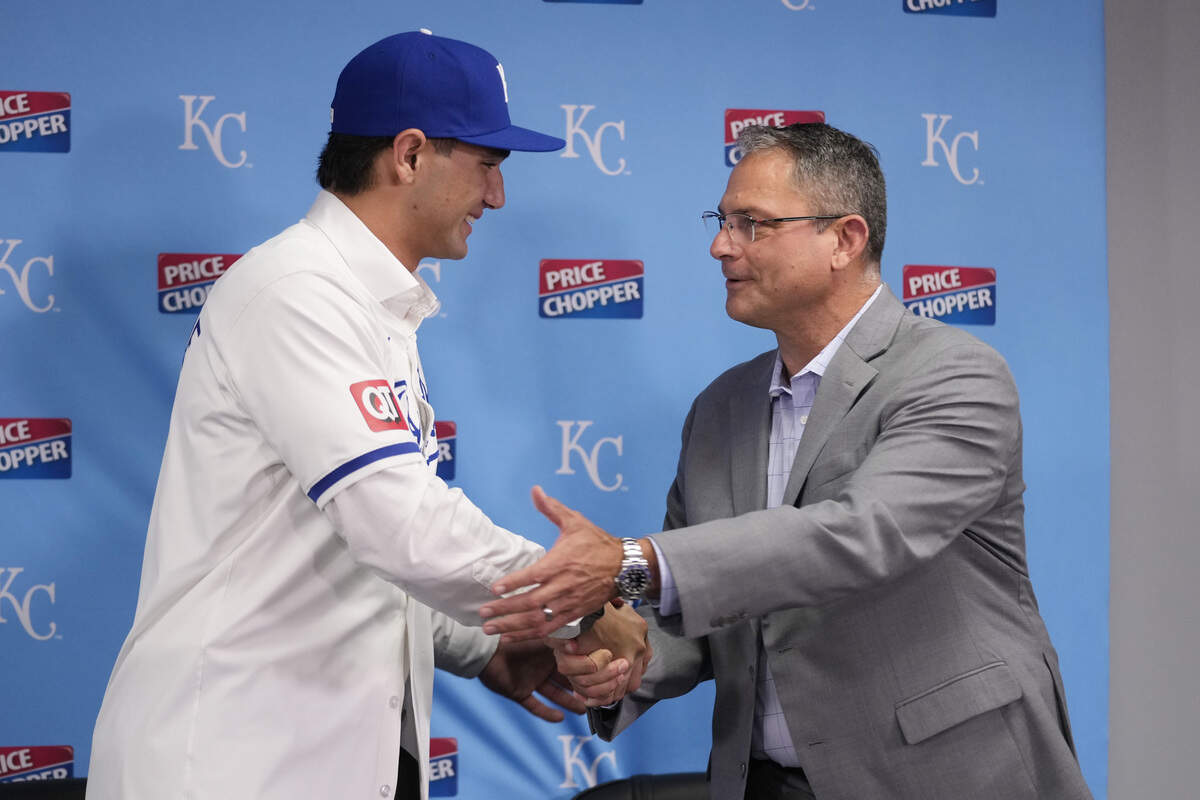 Jac Caglianone, the Kansas City Royals’ first-round draft pick, shakes hands with general manager J.J. Picollo as he is introduced during a press conference prior to a game between the Arizona Diamondbacks Kansas City Royals at Kauffman Stadium on July 24, 2024 in Kansas City, Missouri.