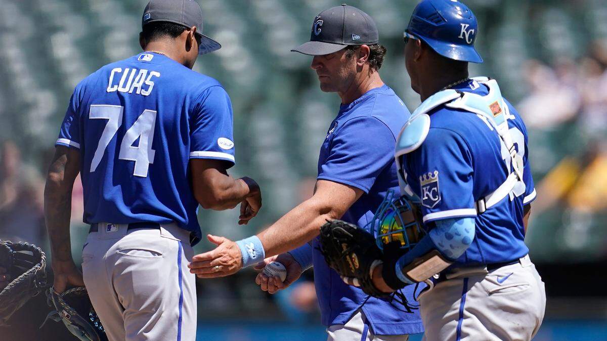 Kansas City Royals pitcher Jose Cuas (74) walks off the mound after handing the ball to manager Mike Matheny, middle, as catcher Salvador Perez watches during the sixth inning of a baseball game against the Oakland Athletics in Oakland, Calif., Sunday, June 19, 2022. (AP Photo/Jeff Chiu)