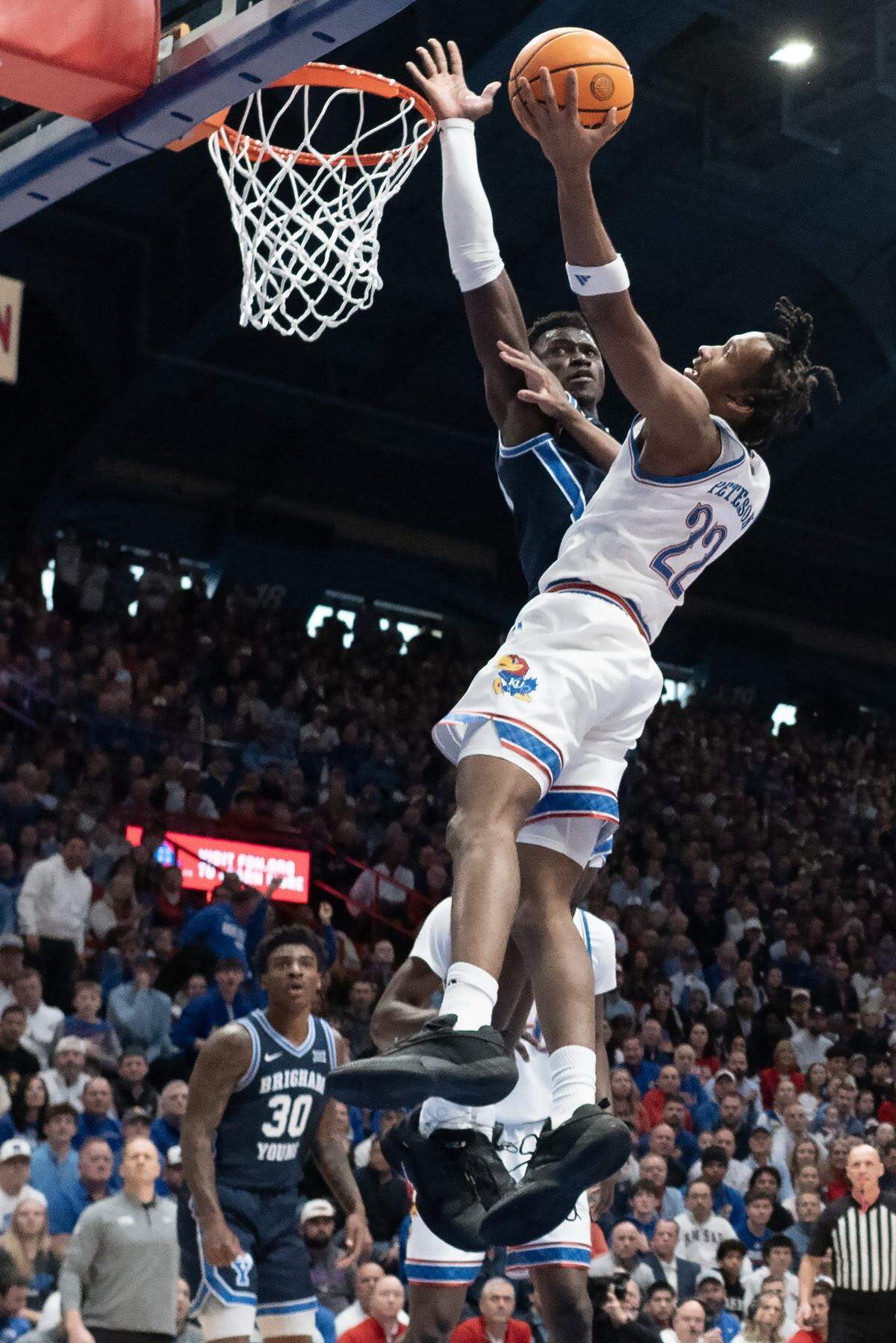 Kansas Jayhawks guard Darryn Peterson (22) goes in for a layup as BYU Cougars center Keba Keita (13) blocks in the first half at Allen Fieldhouse on Saturday, Jan. 31, 2026, in Lawrence.