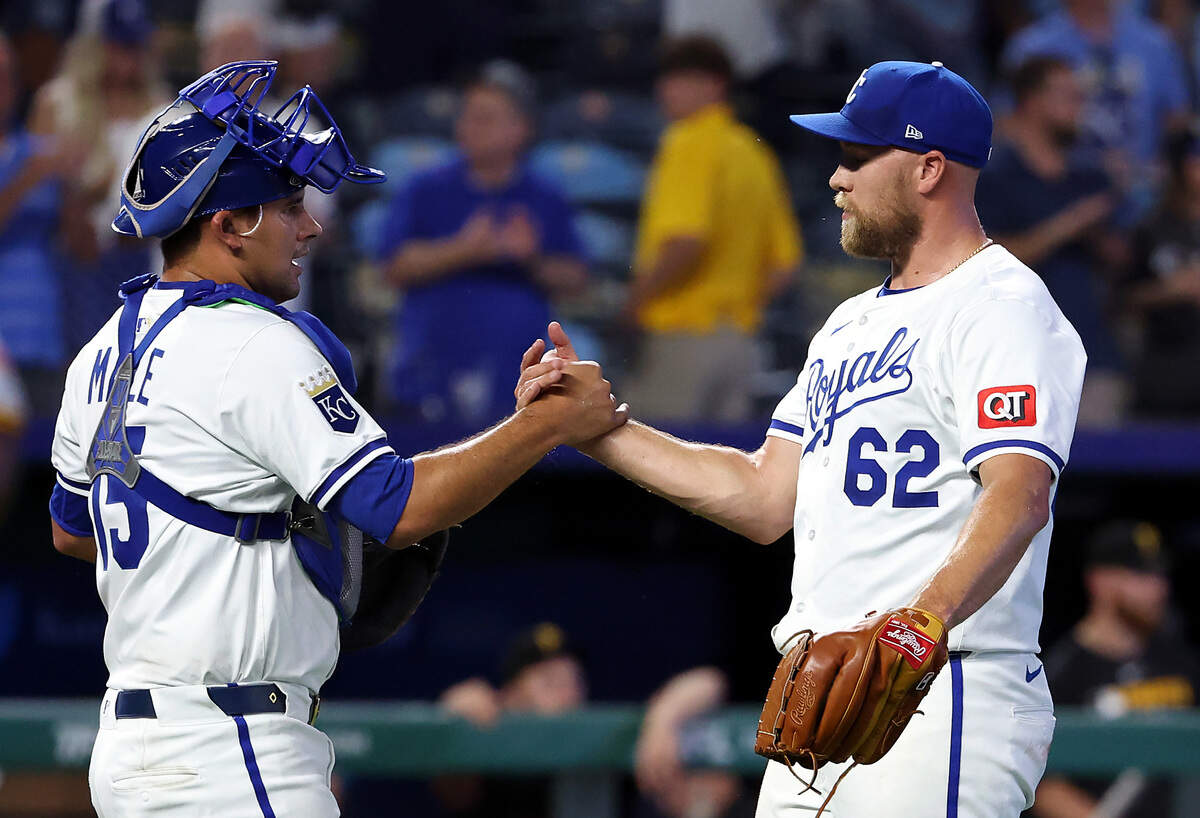 Jonathan Bowlan and Luke Maile of the Kansas City Royals congratulate each other after the Royals defeated the Pittsburgh Pirates 9-3 to win the game at Kauffman Stadium on July 07, 2025 in Kansas City, Missouri.