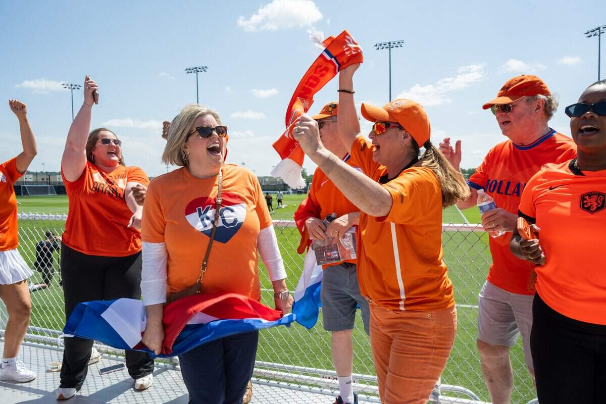 Fans dance in support of the Netherlands soccer team during the team's open practice on Wednesday, June 10, 2026, in Riverside. The Dutch national team will train between matches at the Kansas City Current training facility.
