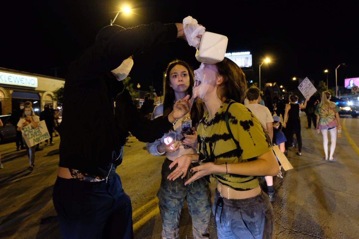 Protesters used milk to counteract a chemical spray used by police near West 40th Terrance and Broadway Bouleavard Friday night after marchers left a protest at the Country Club Plaza.