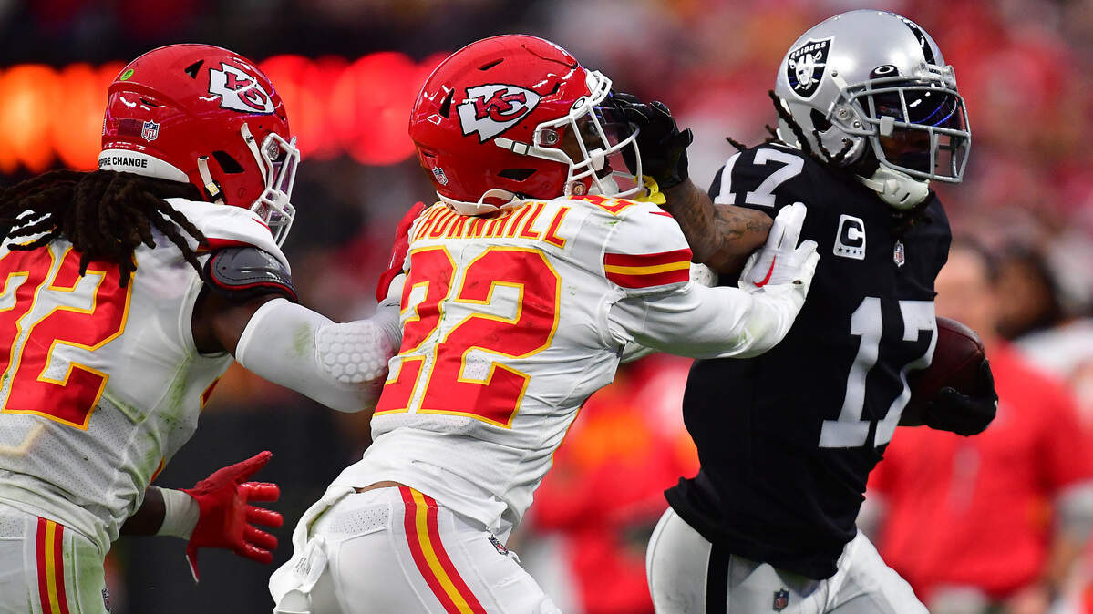 Las Vegas Raiders wide receiver Davante Adams (17) runs the ball against former Kansas City Chiefs safety Juan Thornhill (22) during the first half at Allegiant Stadium on Jan. 7, 2023.