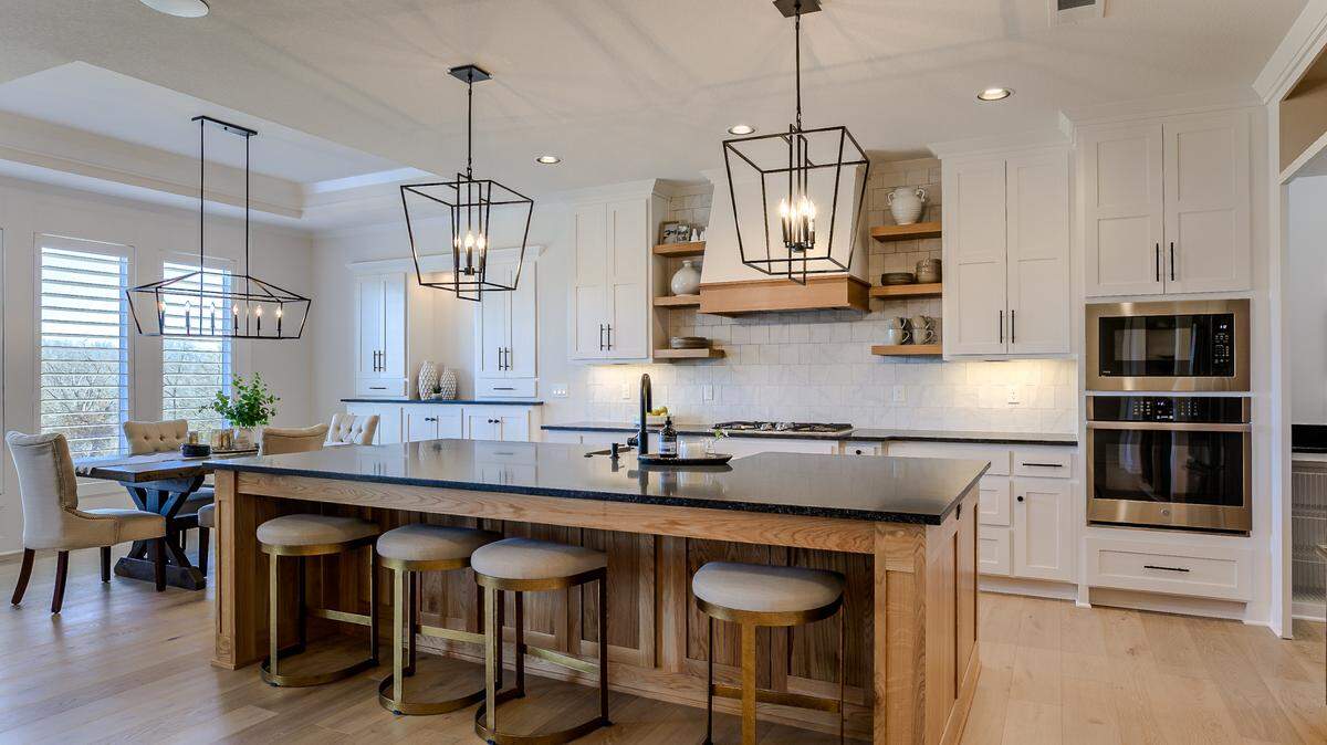 The reverse 1.5-story Jefferson EX by Bickimer Homes captures the heart of modern lifestyles, with a gourmet-inspired kitchen boasting plenty of countertop workspace, stylish storage, and an oversized island. This four-bedroom floor plan is available on two homesites in the Willow Pointe neighborhood.