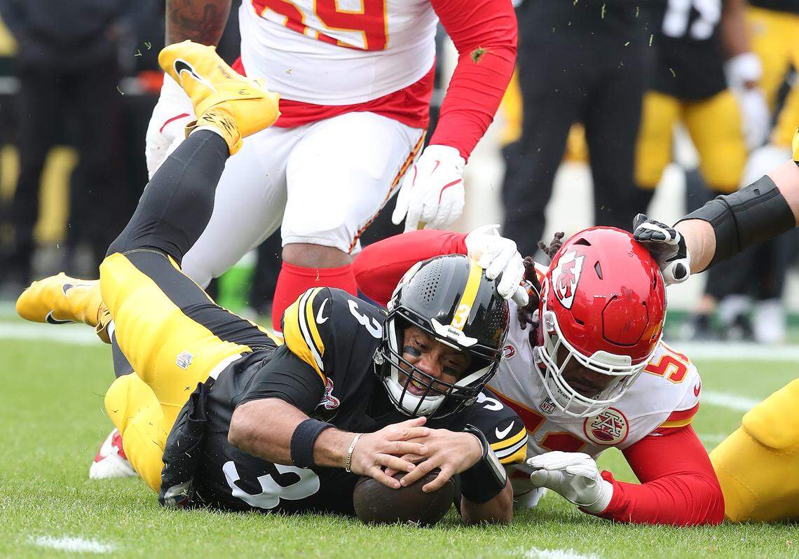 Pittsburgh Steelers quarterback Russell Wilson (No. 3) recovers his own fumble ahead of Kansas City Chiefs defensive end Mike Danna during an NFL Week 17 game at Acrisure Stadium in Pittsburgh, Pennsylvania on Wednesday, Dec 25, 2024.