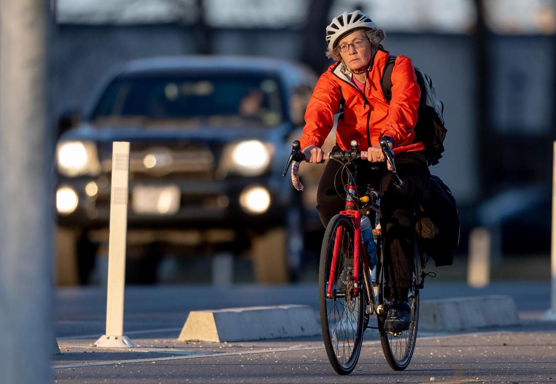 Abby Mueller rides her bike home from work on Tuesday, Nov. 22, 2022 in Kansas City.