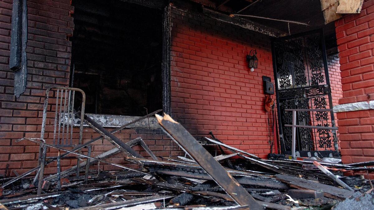 Charred brick and burnt wood remains after a fire destroyed a home in the 3200 block of Lockridge Avenue on Thursday, Dec. 8, 2022, in Kansas City. Firefighters discovered a man’s body while extinguishing the fire.