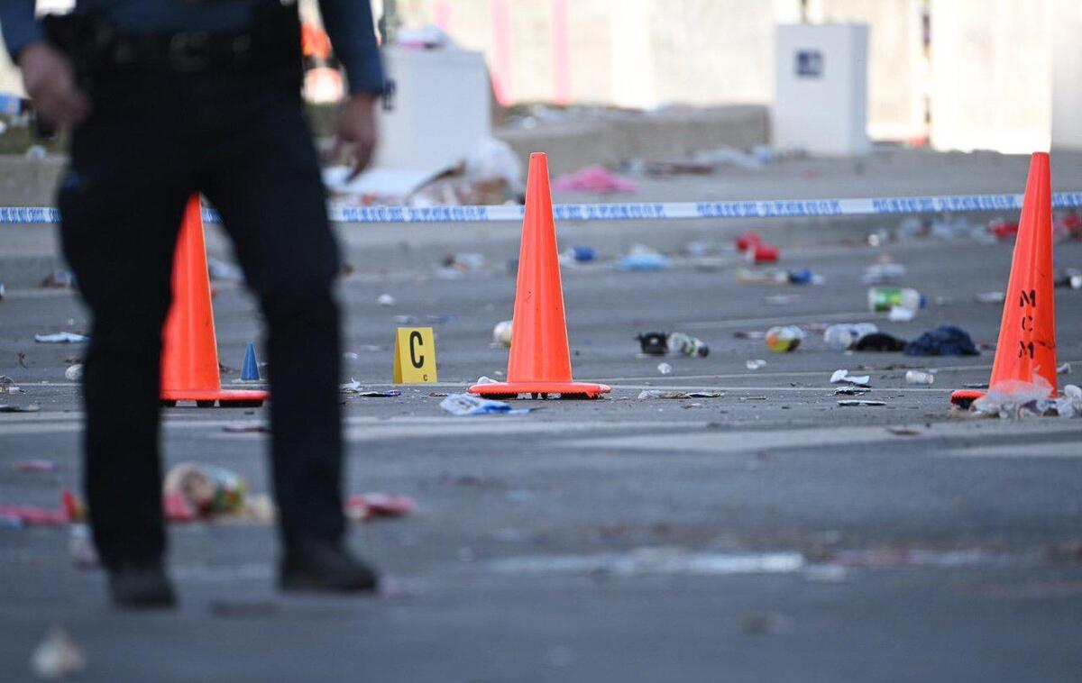 Police officers investigate the scene of a shooting where at least one person was killed and more than 20 others were injured after the Kansas City Chiefs Super Bowl LVIII victory parade Wednesday, Feb. 14, 2024, in Kansas City.