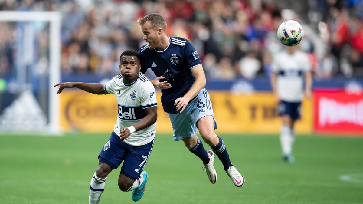 Sporting Kansas City’s Uri Rosell, airborne, and the Vancouver Whitecaps’ Deiber Caicedo vie for the ball during the first half of last Saturday night’s match at B.C. Place stadium in Vancouver, Canada.