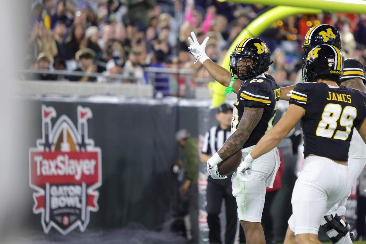 Jamal Roberts #20 of the Missouri Tigers celebrates a touchdown on the opening drive of the 2025 TaxSlayer Gator Bowl between the Missouri Tigers and&nbsp;Virginia Cavaliers at EverBank Stadium on December 27, 2025 in Jacksonville, Florida.