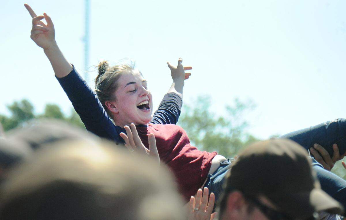 A concert-goer crowd surfs over the mosh pit in 2016 as Sevendust performs during RockFest at Liberty Memorial in downtown Kansas City.