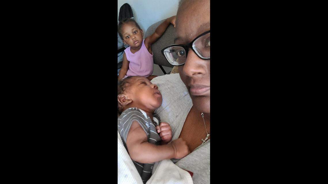 Tamika Horton holds her grandson, Levite, beside her granddaughter, Nova, in the weeks after her daughter, Braxten Goodwin, died of the coronavirus.