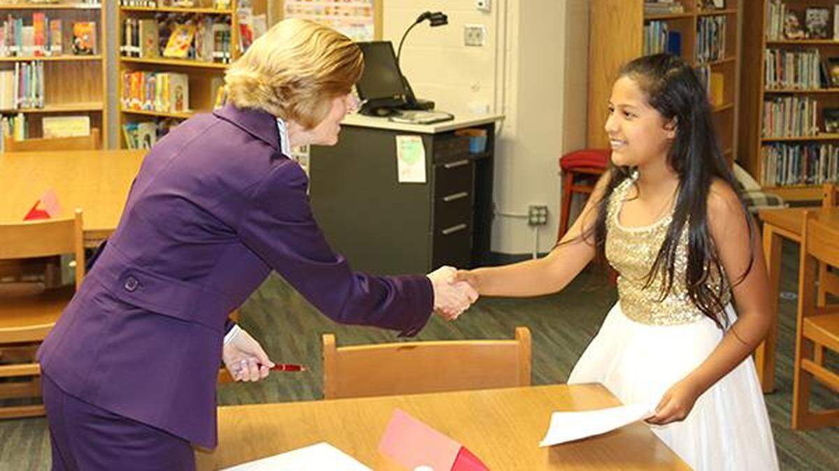 Dressed for the occasion, fifth-grader Erika Sanchez shakes the hand of her interviewer, Cathy Donovan, at Central Elementary School. Donovan, director of staffing and talent acquisition for the Olathe Public Schools, has begun a three-year term as president of the American Association of School Personnel Administrators.