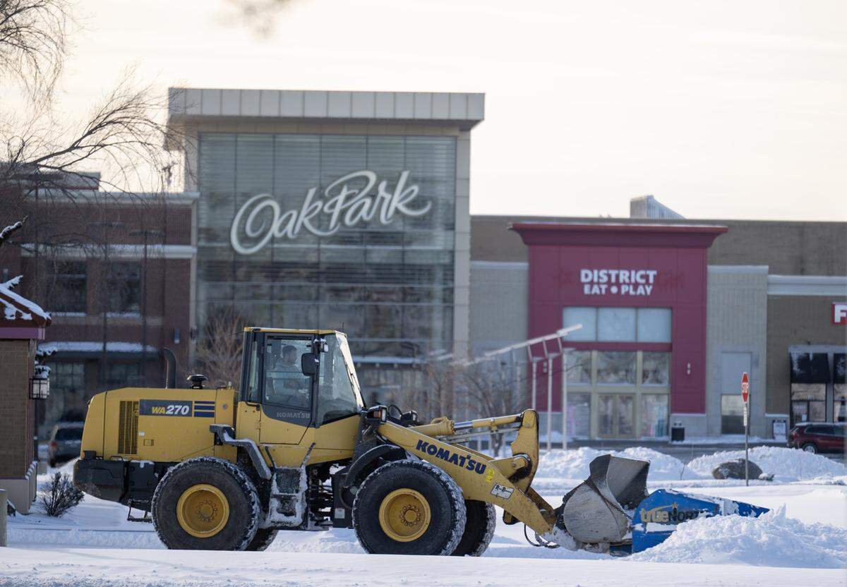In the wake of a powerful winter storm, crews deployed heavy machinery to clear snow from the Oak Park Mall parking lot in Overland Park on Sunday, Jan. 25, 2026.